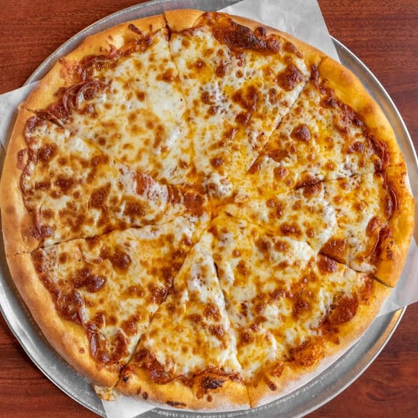 A whole cheese pizza, sliced into eight pieces, on a metal tray at Pizza Bella Italian Bistro.